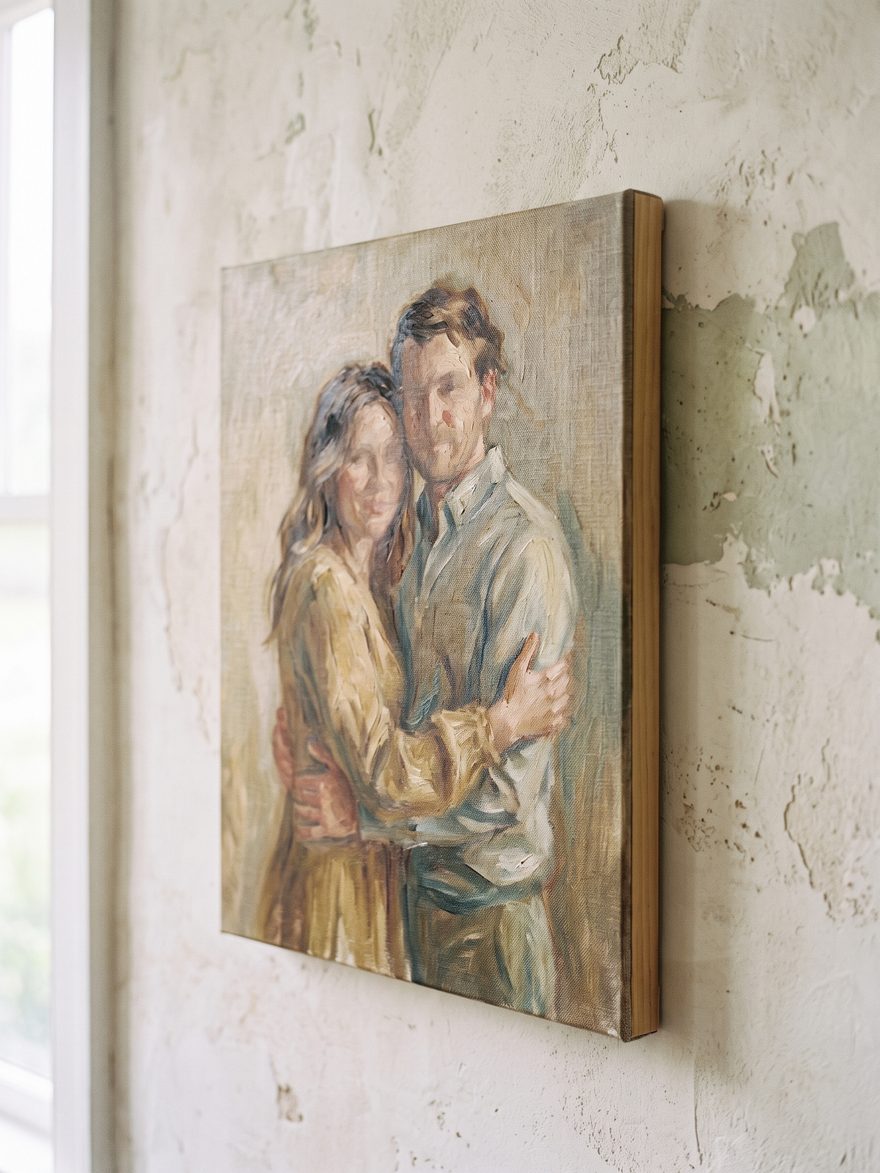 A couple portrait in oil on a gallery-wrapped canvas, the weave and stretcher depth visible.